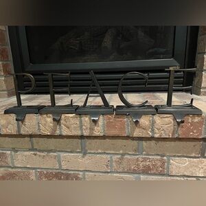 Pottery Barn stocking holders spelling PEACE.